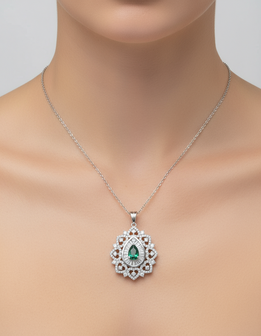 Necklace with a pendant featuring a green gemstone and diamonds on a mannequin.